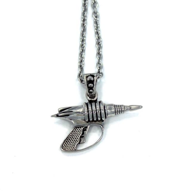 back view of the Zap pendant in silver on a white surface