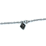 shot of the hc tag on the cable chain of the zap pendant in silver