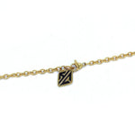 shot of the hc tag on the cable chain of the zap pendant in gold