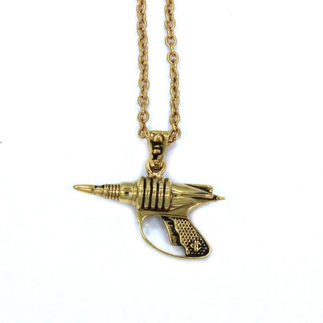 front view of the Zap pendant in gold on a white surface