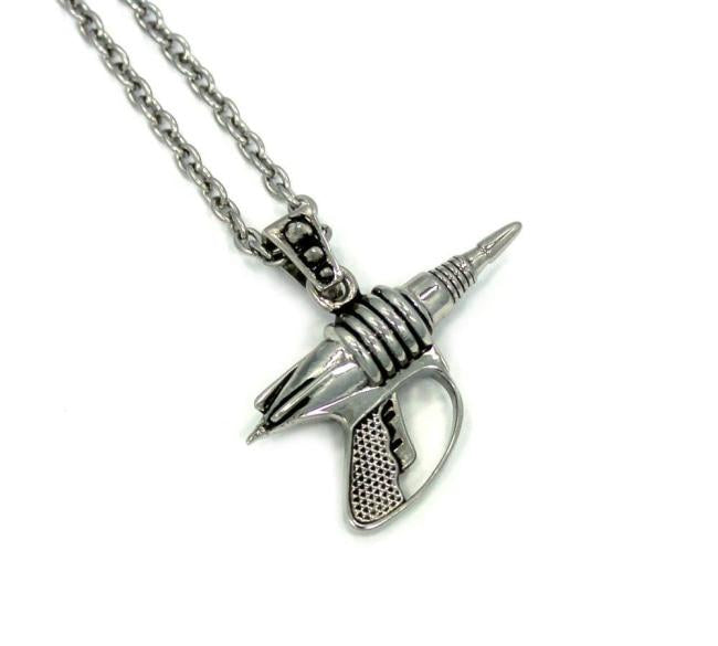 right side view of the Zap pendant in silver on a white surface