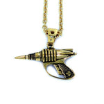up close back shot of the Zap pendant in gold on a white surface