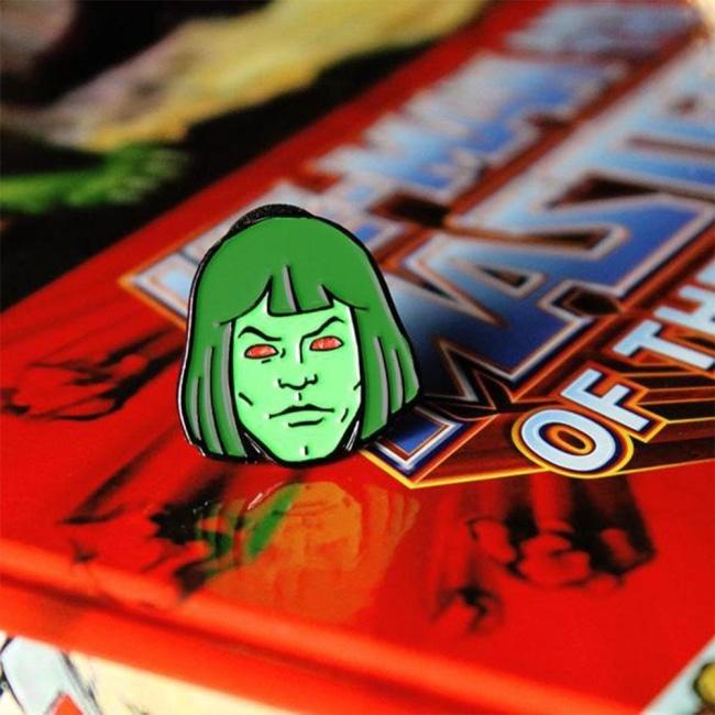 front shot of the Zombie horde He-Man enamel pin on a masters of the universe book